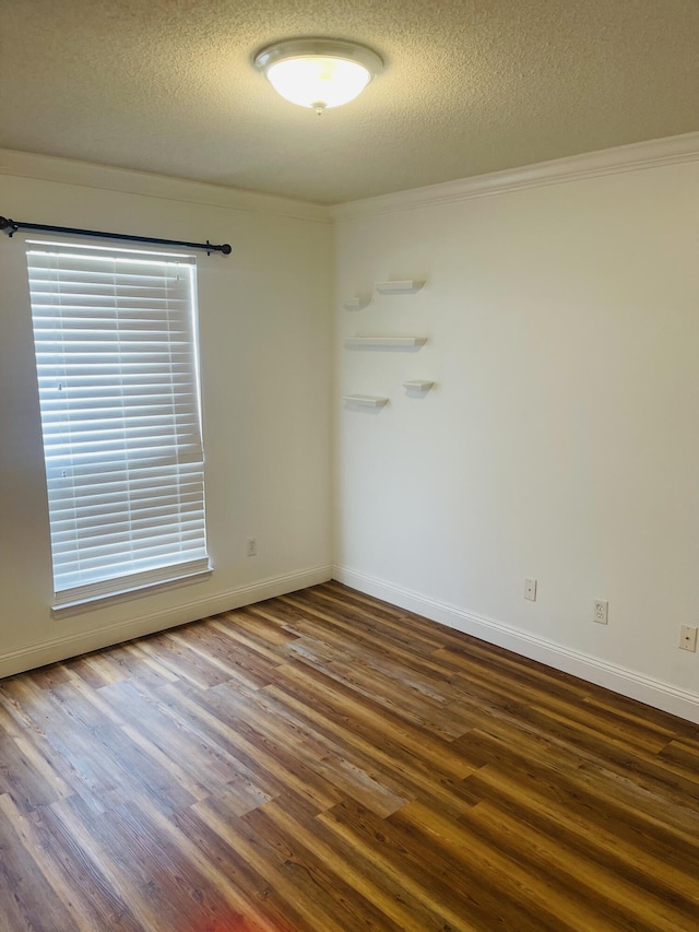 437 Hatchee Dr, Crestview, FL 32536 - spare room featuring wood finished floors, ornamental molding, a textured ceiling, and baseboards