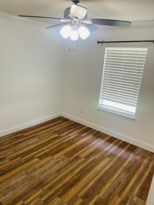 437 Hatchee Dr, Crestview, FL 32536 - empty room featuring ceiling fan, baseboards, dark wood-type flooring, and crown molding