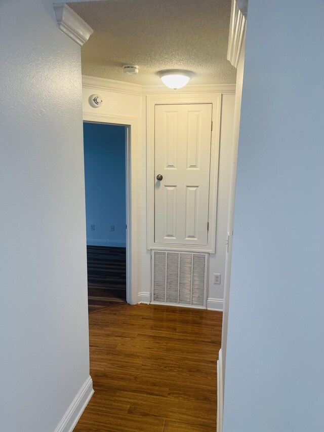 437 Hatchee Dr, Crestview, FL 32536 - hallway featuring baseboards, wood finished floors, and a textured ceiling