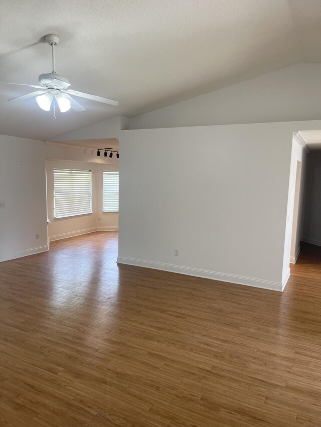 437 Hatchee Dr, Crestview, FL 32536 - empty room with lofted ceiling, wood finished floors, a ceiling fan, and baseboards