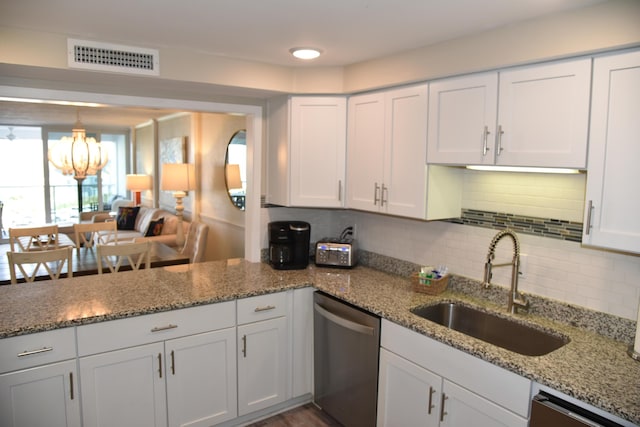 900 Gulf Shore Dr Unit 3042, Destin, FL 32541 - kitchen with stainless steel dishwasher, a sink, a chandelier, white cabinets, and backsplash