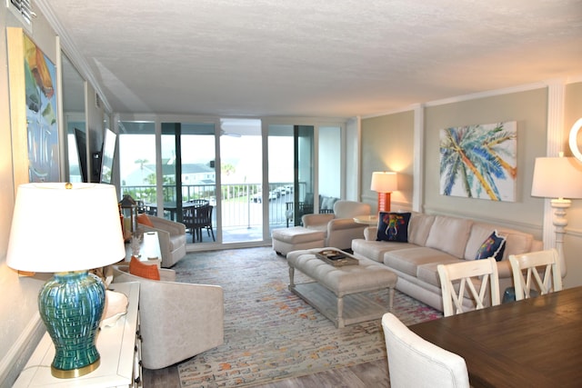900 Gulf Shore Dr Unit 3042, Destin, FL 32541 - living area featuring wood finished floors, a wall of windows, a textured ceiling, and baseboards