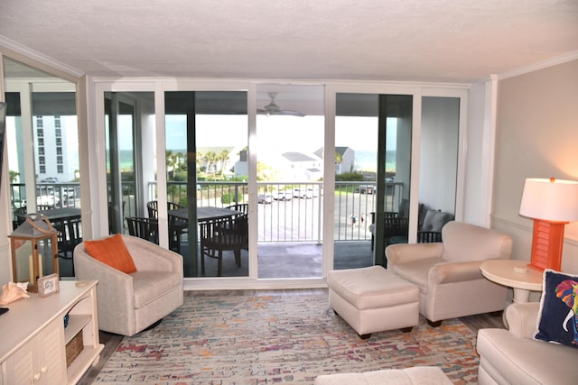 900 Gulf Shore Dr Unit 3042, Destin, FL 32541 - living room with wood finished floors, ceiling fan, crown molding, expansive windows, and a textured ceiling