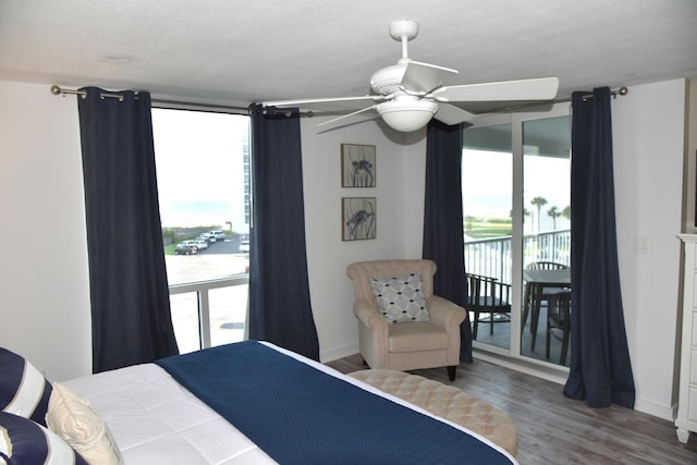 900 Gulf Shore Dr Unit 3042, Destin, FL 32541 - bedroom featuring access to exterior, multiple windows, wood finished floors, and baseboards