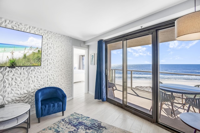 900 Gulf Shore Dr Unit 3042, Destin, FL 32541 - sitting room featuring view of water and beach, baseboards, and wood finished floors