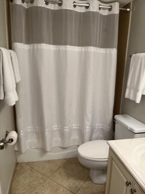11757 Front Beach Rd Unit W600, Panama City Beach, FL 32407 - bathroom featuring toilet, shower / bath combo with shower curtain, tile patterned flooring, and vanity