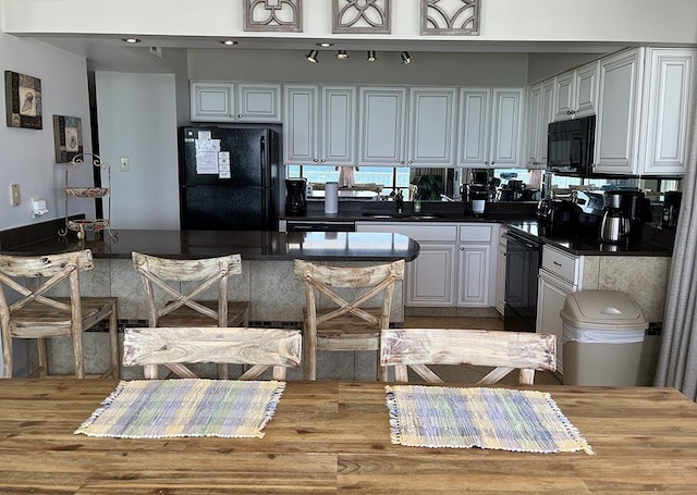 11757 Front Beach Rd Unit W600, Panama City Beach, FL 32407 - kitchen featuring a sink, dark countertops, black appliances, and white cabinetry