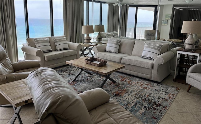 11757 Front Beach Rd Unit W600, Panama City Beach, FL 32407 - living area featuring a water view, ceiling fan, floor to ceiling windows, and light tile patterned floors