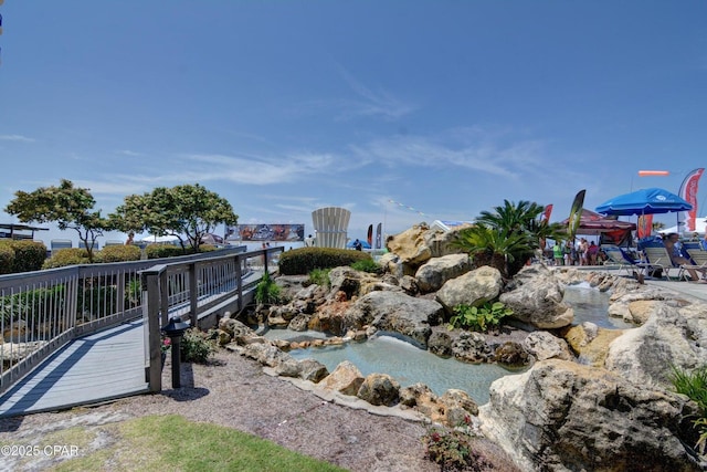11757 Front Beach Rd Unit W600, Panama City Beach, FL 32407 - view of property's community featuring a garden pond and a deck