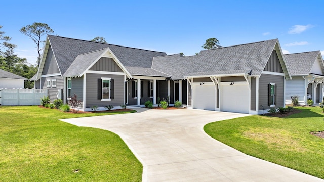 view of front of property with board and batten siding, driveway, roof with shingles, fence, and an attached garage