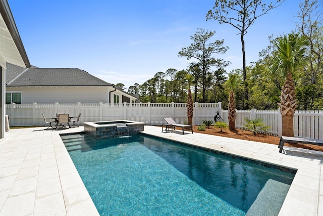 view of swimming pool with a pool with connected hot tub, a fenced backyard, and a patio area