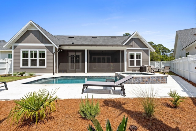 rear view of property with a fenced backyard, a patio, and board and batten siding
