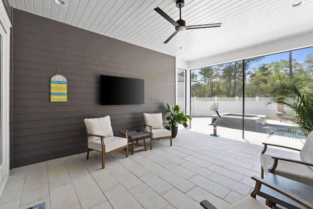 view of patio / terrace featuring ceiling fan, a pool with connected hot tub, and a fenced backyard