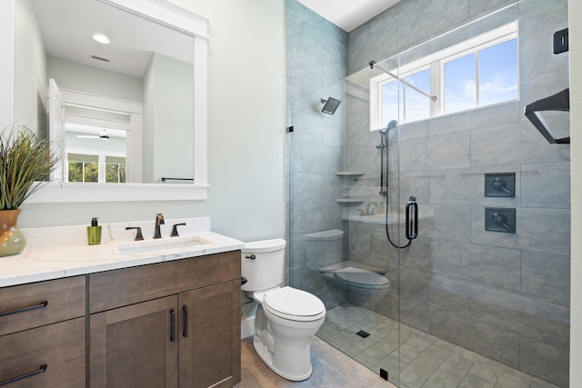 bathroom with vanity, a stall shower, visible vents, and toilet