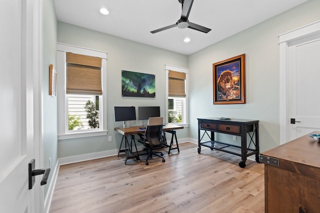 office with plenty of natural light, light wood finished floors, and ceiling fan