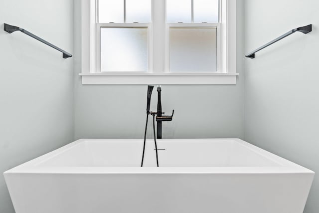 full bath with a sink and a soaking tub