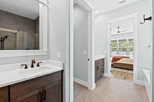 full bathroom featuring a tile shower, vanity, a ceiling fan, ensuite bathroom, and visible vents