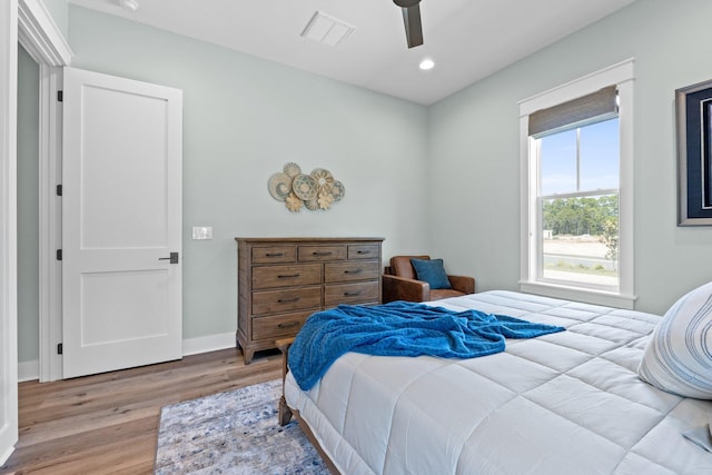 bedroom with ceiling fan, recessed lighting, baseboards, wood finished floors, and visible vents