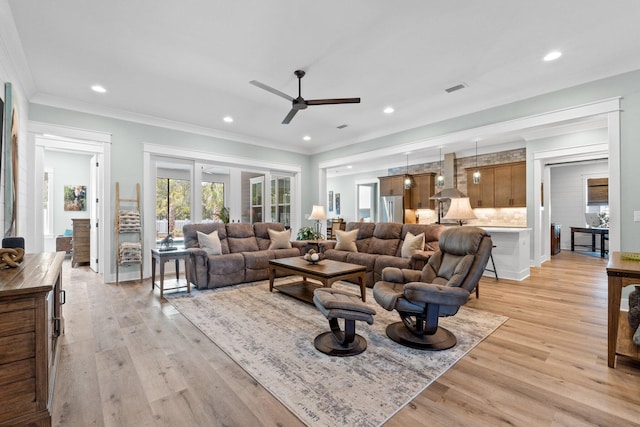 living room with light wood-type flooring, ceiling fan, ornamental molding, and recessed lighting