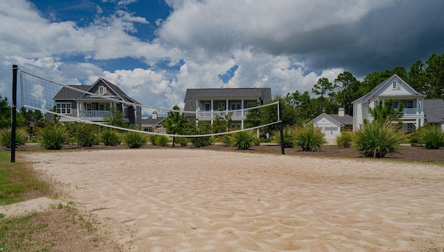 view of community featuring driveway and volleyball court