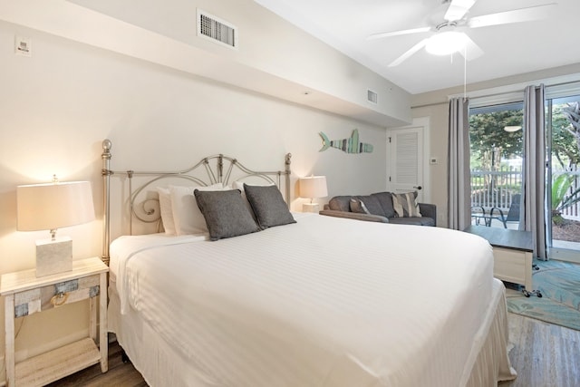 bedroom with access to exterior, wood finished floors, and visible vents