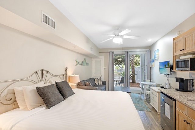 bedroom with access to outside, ceiling fan, visible vents, and wood finished floors