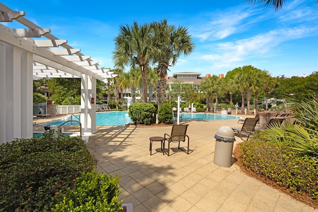 community pool featuring a pergola, fence, and a patio