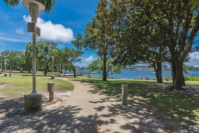 view of community featuring a water view and a lawn