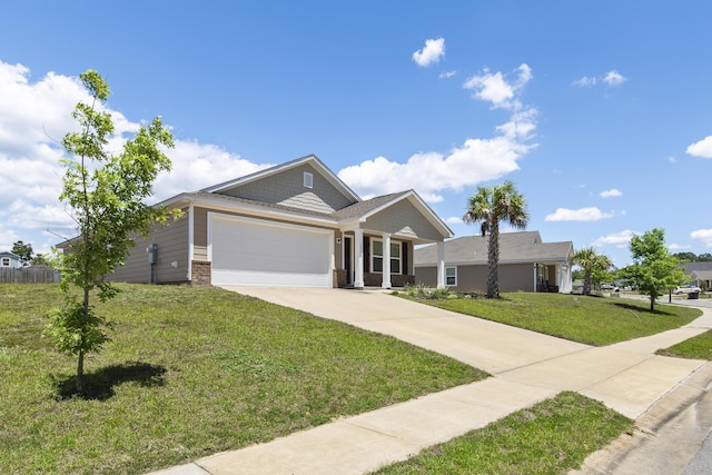 ranch-style house featuring driveway, an attached garage, and a front yard