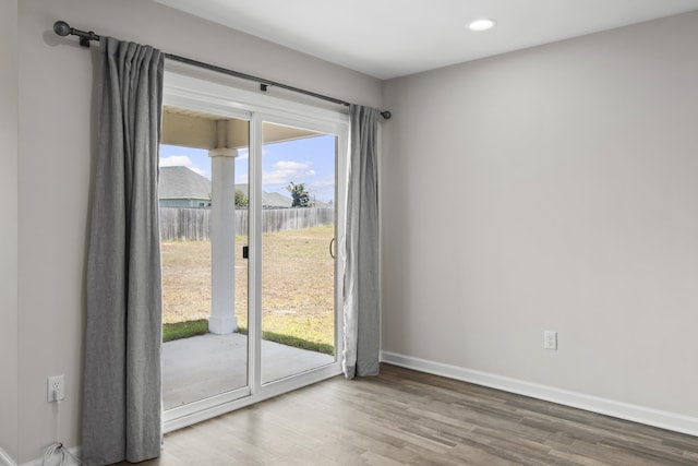 entryway with baseboards, recessed lighting, and wood finished floors