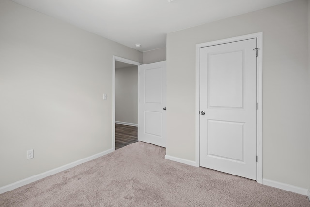 unfurnished bedroom with carpet and baseboards