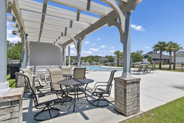 view of patio / terrace featuring a pergola, fence, and a community pool