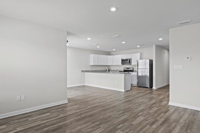 kitchen featuring recessed lighting, baseboards, white cabinets, and appliances with stainless steel finishes