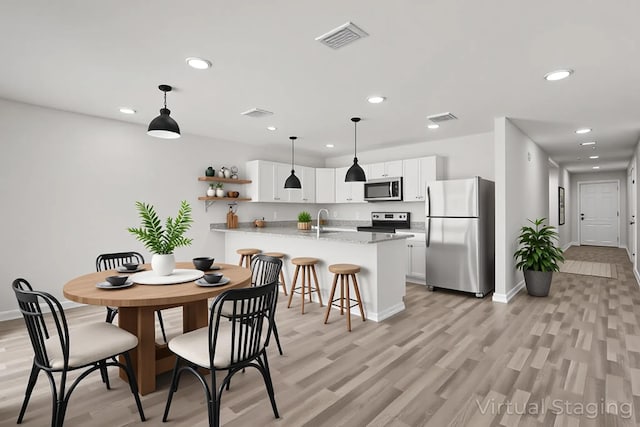 685 Whispering Creek Ave, Freeport, FL 32439 - dining area with light wood finished floors and recessed lighting
