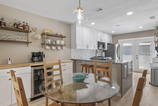 399 Linkside Dr, Miramar Beach, FL 32550 - dining area featuring beverage cooler, light wood-style flooring, french doors, and recessed lighting