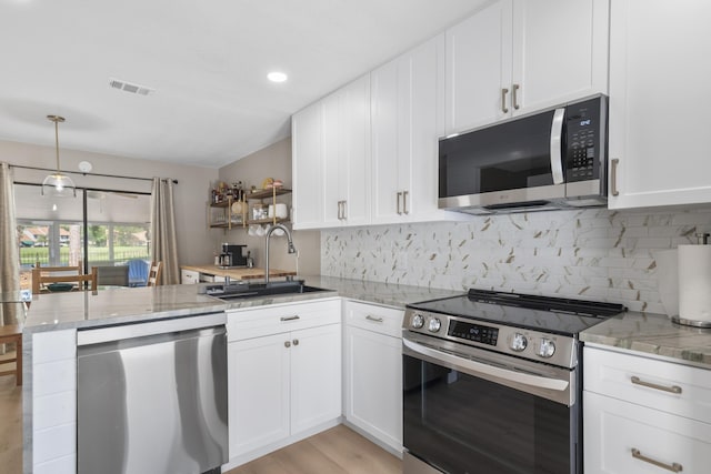 399 Linkside Dr, Miramar Beach, FL 32550 - kitchen with appliances with stainless steel finishes, a sink, a peninsula, white cabinetry, and recessed lighting