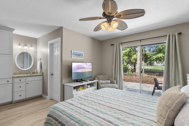 399 Linkside Dr, Miramar Beach, FL 32550 - bedroom with access to outside, light wood-type flooring, ensuite bath, a ceiling fan, and a textured ceiling