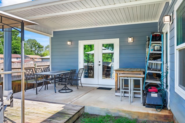 view of patio / terrace with french doors, outdoor dining area, and fence