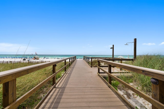 dock area featuring a water view and a view of the beach