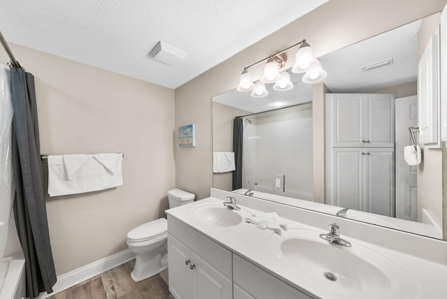 full bath with a sink, toilet, wood finished floors, and visible vents