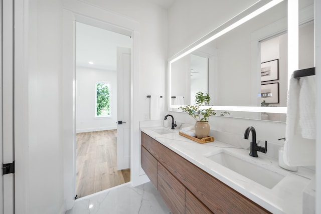2456 Belmar Ct, Panama City Beach, FL 32408 - bathroom with double vanity, baseboards, a sink, and marble finish floor