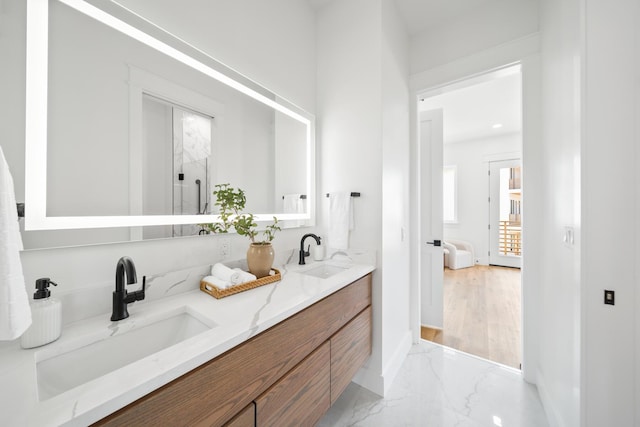 2456 Belmar Ct, Panama City Beach, FL 32408 - bathroom featuring double vanity, baseboards, a sink, and marble finish floor