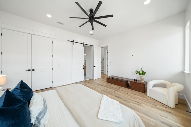 2456 Belmar Ct, Panama City Beach, FL 32408 - bedroom with a closet, baseboards, recessed lighting, a barn door, and light wood finished floors