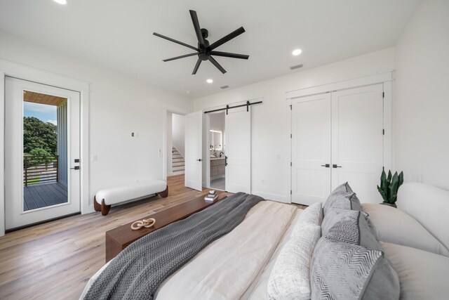 2456 Belmar Ct, Panama City Beach, FL 32408 - bedroom with visible vents, access to exterior, light wood-style floors, recessed lighting, and a barn door