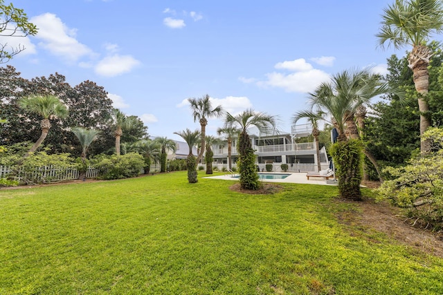 view of yard with fence, an outdoor pool, and a patio area