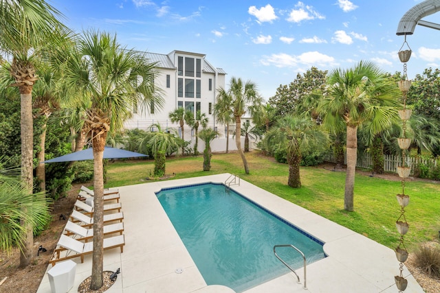 view of swimming pool with a fenced in pool, fence, and a lawn