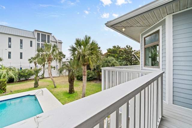 exterior space featuring a lawn and an outdoor pool