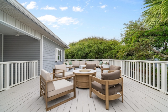 wooden terrace with an outdoor living space