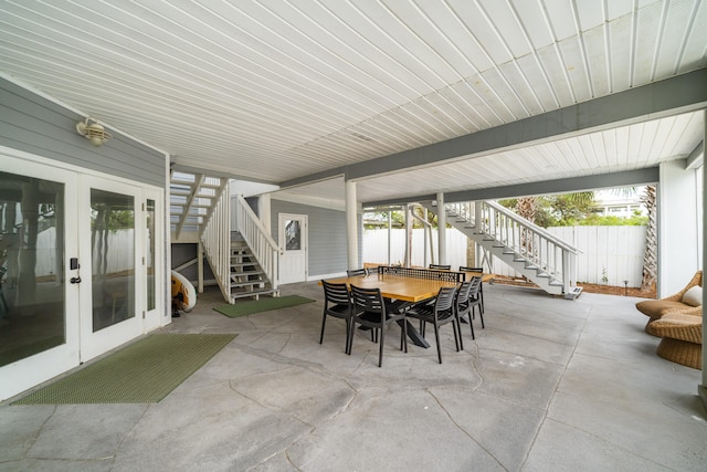 view of patio / terrace featuring outdoor dining area, fence, french doors, and stairs