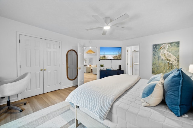 bedroom with a closet, a ceiling fan, light wood-style flooring, and ensuite bathroom